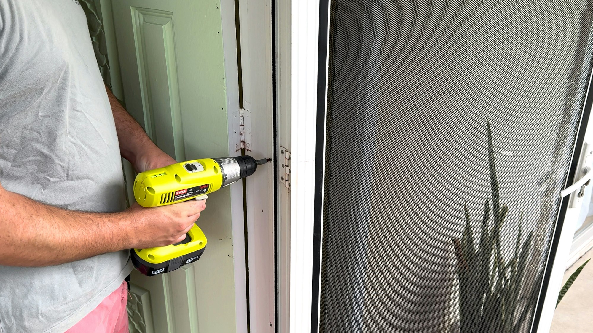 Removing screen door with drill